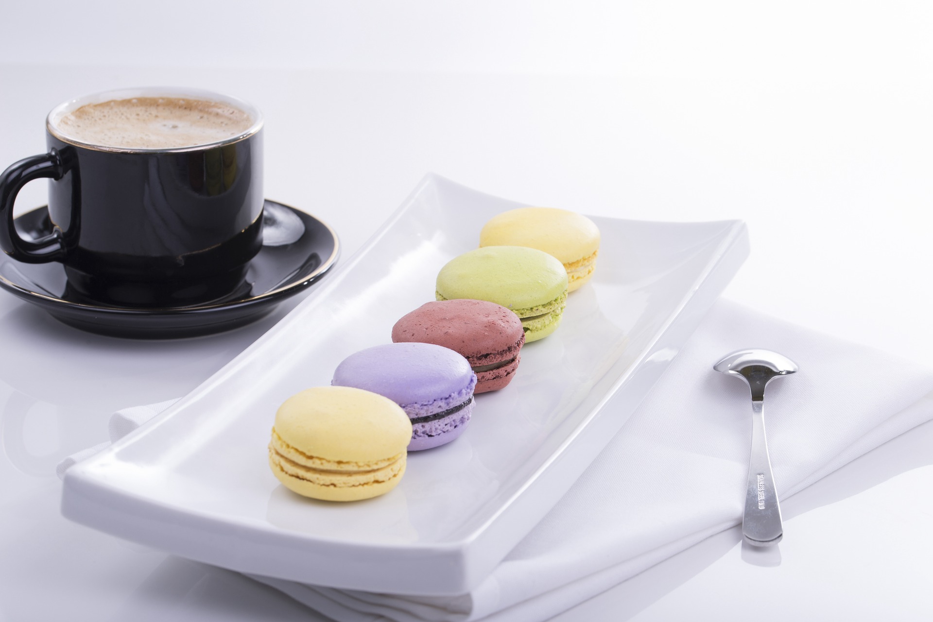 Macarons on a plate with coffee cup